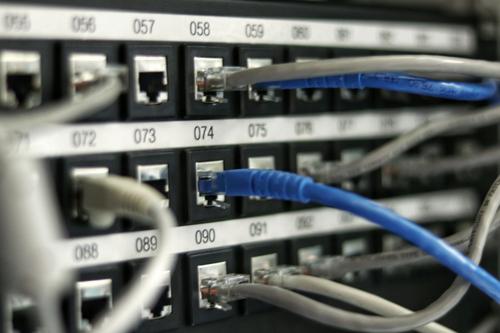 Patch panel with numbered ports and network cables